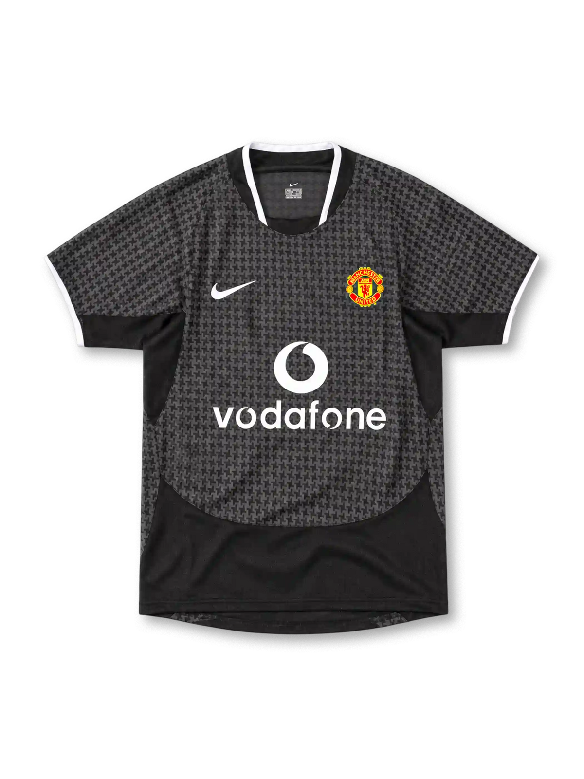 Manchester United 2003/05 Nike away jersey in black and charcoal grey with an all-over geometric pattern, white-trimmed collar and sleeve cuffs, white Nike Swoosh, Manchester United crest and Vodafone sponsor.