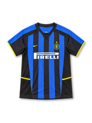 Inter Milan 2002/03 Nike home jersey featuring blue-and-black vertical stripes, black V-neck collar, yellow Nike logo, Inter crest with gold star, white Pirelli sponsor, and yellow sleeve and side accents.