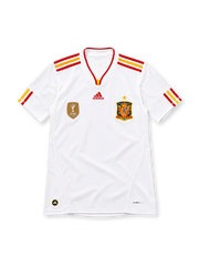 Spain 2011/12 white adidas away jersey with red and yellow shoulder stripes, red-trimmed V-neck collar, gold FIFA World Champions 2010 badge, Spain crest with gold star, red adidas logo, and CLIMACOOL detailing.