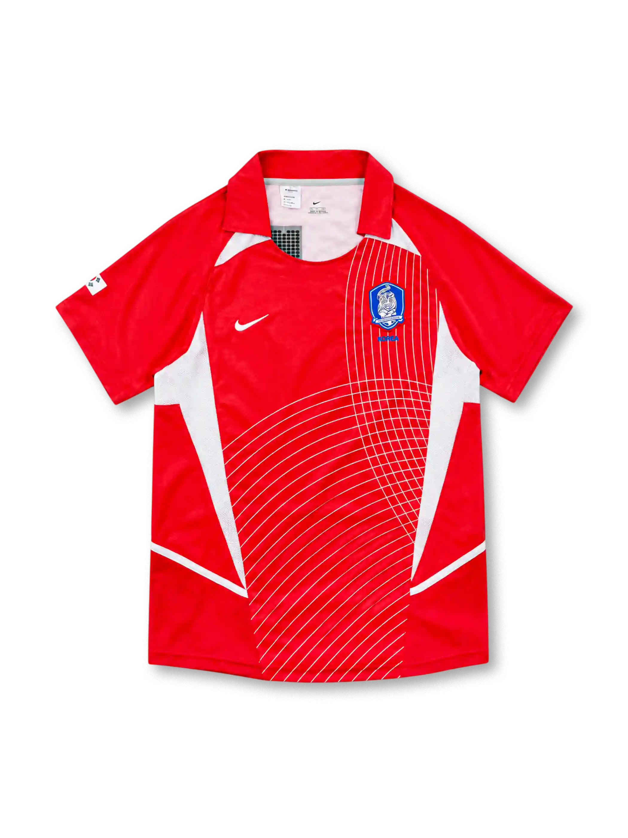 South Korea 2002 Nike home jersey in bright red with white geometric side panels, curved white line graphics across the front, red fold-down collar, white Nike Swoosh, and blue Korea Football Association crest.