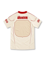 Galatasaray 2010/11 cream away jersey with tonal lion graphic, red adidas stripes and Türk Telekom sponsor