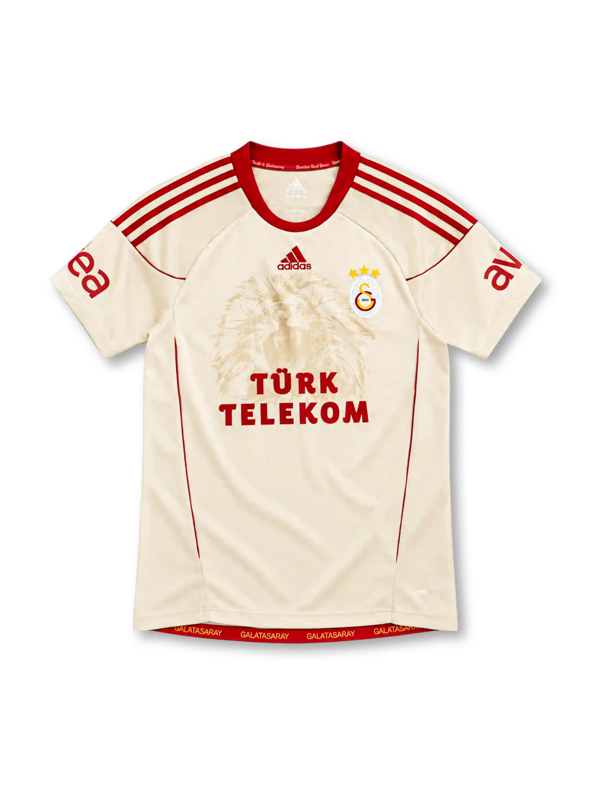 Galatasaray 2010/11 cream away jersey with tonal lion graphic, red adidas stripes and Türk Telekom sponsor