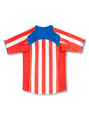Back view of Atletico Madrid 2004/05 home jersey with red and white stripes, blue upper-back panel and yellow piping.