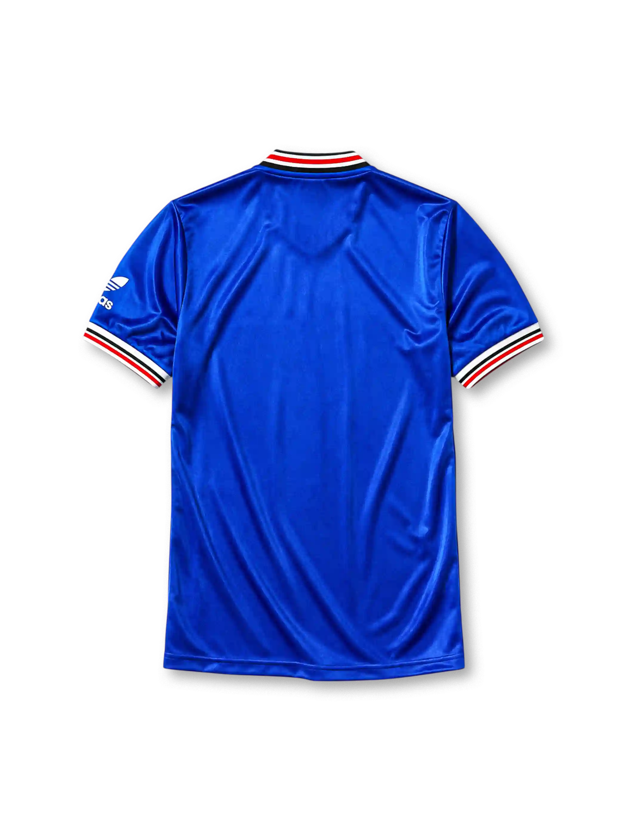 Manchester United 1985-86 third jersey, front view, royal blue body, white striped V-neck collar, white sleeve panels with black and red trim, adidas trefoil logo on sleeve, club crest, SHARP sponsor logo, striped ribbed cuffs