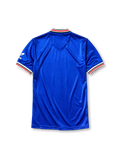 Manchester United 1985-86 third jersey, front view, royal blue body, white striped V-neck collar, white sleeve panels with black and red trim, adidas trefoil logo on sleeve, club crest, SHARP sponsor logo, striped ribbed cuffs