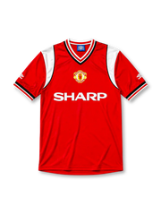 Manchester United 1984-86 home jersey, front view, red body, white sleeve panels with black and red trim, red white and black striped V-neck collar, Umbro diamond logo on sleeves, club crest, SHARP sponsor logo, striped ribbed cuffs
