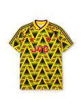 Arsenal 1991-93 away jersey, front view, yellow body with black gradient zigzag pattern, yellow V-neck collar with black and red trim, red piping, adidas trefoil logo, club cannon crest, JVC sponsor logo, striped sleeve trim