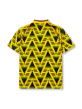 Arsenal 1991-93 away jersey, front view, yellow body with black gradient zigzag pattern, yellow V-neck collar with black and red trim, red piping, adidas trefoil logo, club cannon crest, JVC sponsor logo, striped sleeve trim