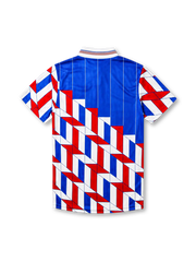 Ajax 1989-90 away jersey, front view, blue upper body with pinstripes, red white and blue geometric chevron pattern on lower body and sleeves, striped funnel collar, Umbro diamond logo, club crest, TDK sponsor logo