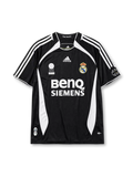 Real Madrid 2006-07 third jersey, front view, black body with white side panels, adidas three-stripe shoulder detailing, FIFA Best Club of the Century emblem, adidas logo, club crest, BenQ Siemens sponsor logo, sleeve patch