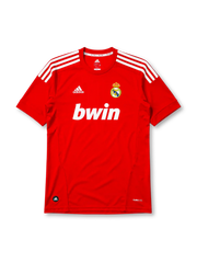 Real Madrid 2011-12 third jersey, front view, red body, white adidas three-stripe shoulder detailing, crew neck collar, adidas logo, club crest, bwin sponsor logo, Climacool label