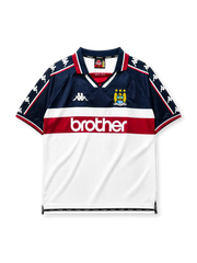 Manchester City 1997-98 away jersey, front view, navy upper body with white and maroon lower blocks, point collar with M.C.F.C. text, Kappa Omini sleeve pattern, club crest, Brother sponsor logo
