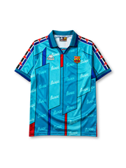 Barcelona 1995-97 away jersey, front view, teal body with angular geometric panels, repeated Barça script pattern, teal point collar, Kappa Omini sleeve pattern, Kappa wordmark, club crest, striped cuffs