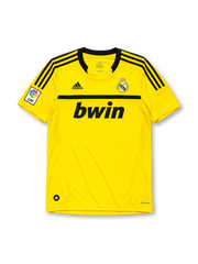 Real Madrid 2011-12 goalkeeper jersey, front view, bright yellow body, black adidas three-stripe shoulder detailing, crew neck collar, LFP league patch, adidas logo, club crest, bwin sponsor logo, Climacool label