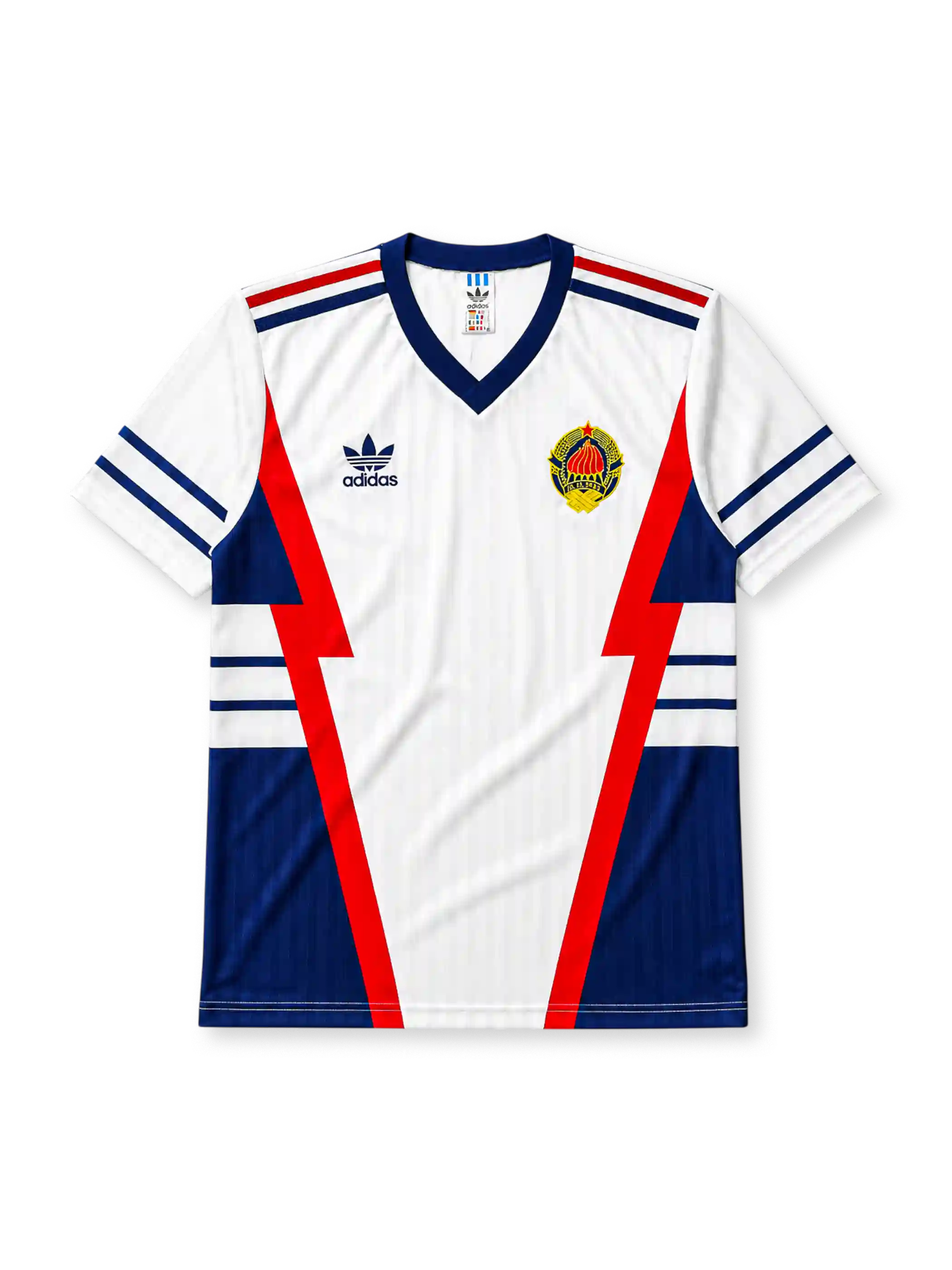 Yugoslavia 1990 World Cup away jersey, front view, white body with red and navy lightning bolt panels, navy V-neck collar, striped cuffs, adidas trefoil logo, national emblem