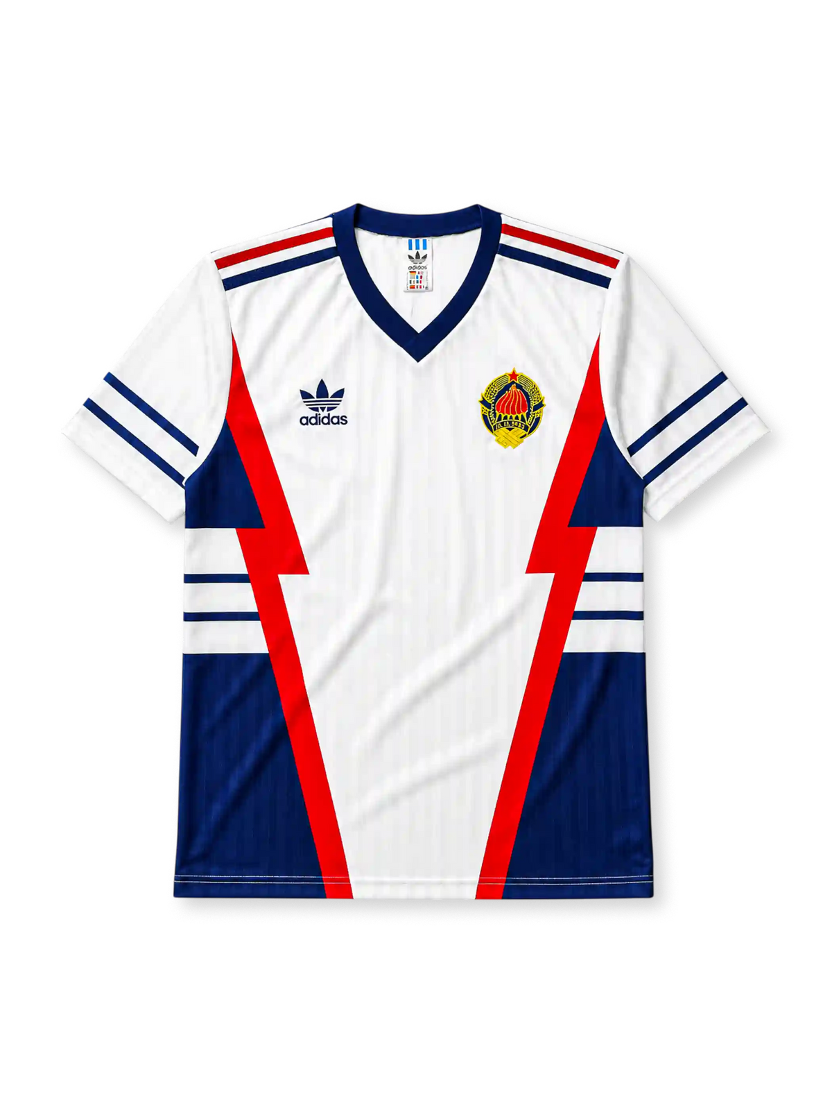 Yugoslavia 1990 World Cup away jersey, front view, white body with red and navy lightning bolt panels, navy V-neck collar, striped cuffs, adidas trefoil logo, national emblem