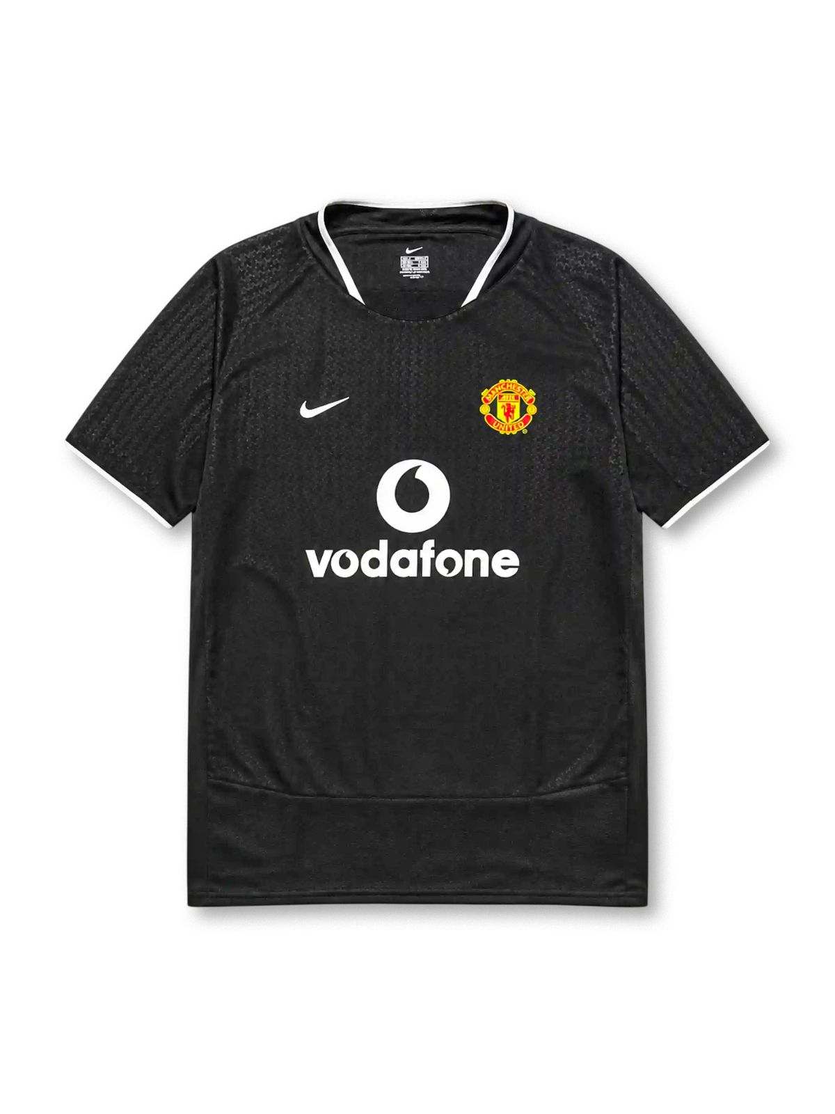 Manchester United 2003-04 away jersey, front view, black body with tonal geometric pattern, white ringer collar and cuffs, Nike swoosh logo, club crest, Vodafone sponsor logo