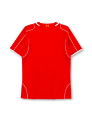 Liverpool 2014-15 home jersey, front view, red body with white piping, V-neck collar, Warrior logo, simplified Liver Bird L.F.C. crest, Standard Chartered sponsor logo