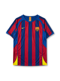 Barcelona 2005-06 home jersey, front view, blue and garnet vertical stripes, crew neck collar with Catalan flag tab, Nike swoosh logo, club crest, yellow side panels