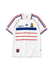 France 1998 World Cup final away jersey, front view, white body with blue and red horizontal stripes, striped raglan sleeves, point collar, FIFA World Cup France 98 text, adidas logo, rooster crest with Bresil France 12-07-98 text, striped cuffs