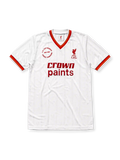 Liverpool 1985-86 away jersey, front view, white body with tonal pinstripe pattern, red V-neck collar with red and yellow stripe trim, striped cuffs, L.F.C. liver bird crest, red Crown Paints sponsor logo, circular 1985-1986 double winners badge on left chest