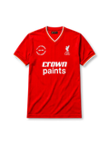 Liverpool 1985-86 home jersey, front view, red body, white V-neck collar with red and yellow stripe trim, white cuffs with yellow stripe, white L.F.C. liver bird crest, white Crown Paints sponsor logo, circular 1985-1986 double winners badge on left chest
