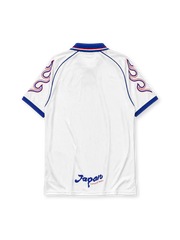 Japan 1998 World Cup away jersey, front view, white body with flame graphic sleeves, blue point collar with red and white stripes, asics logo, JFA crest with golden eagle, Japan text