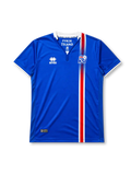Iceland 2016-17 home jersey, front view, blue body with red white and blue central stripe, white point collar with For Iceland text, Errea logo, KSÍ crest
