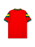 Portugal 1992-94 home jersey, front view, red body with green and yellow sleeve stripes, green V-neck collar with gold script trim, adidas trefoil logo, Portuguese Football Federation crest