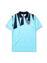 England 1992 third jersey, front view, sky blue body with navy jagged triangle pattern, navy polo-style collar with red and white stripe trim, Three Lions crest with roses