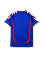 France 2006 home jersey, front view, royal blue body with red crew-neck collar and piping, curved red side panels, white adidas logo and stripes, gold F.F.F. rooster crest with star, small 2006 World Cup emblem near hem, ClimaCool tag