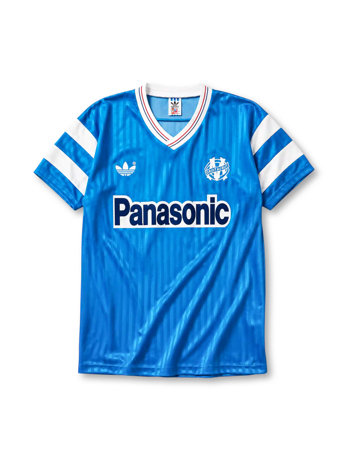 Marseille 1990 away jersey, front view, sky blue body with tonal pinstripe pattern, white V-neck collar with red and blue piping, white adidas trefoil logo, circular Olympique de Marseille crest, navy Panasonic sponsor logo