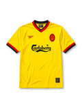 Liverpool 1998 away jersey, front view, bright yellow body, black and red V-neck collar, red Reebok logo, oval red Liverpool crest, black Carlsberg sponsor logo, black and red striped cuffs