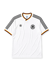 West Germany 1986 home jersey, front view, white body with black red and gold tricolor V-neck collar trim, black adidas trefoil logo and stripes, circular DFB eagle crest, tricolor trimmed cuffs