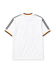 West Germany 1986 home jersey, front view, white body with black red and gold tricolor V-neck collar trim, black adidas trefoil logo and stripes, circular DFB eagle crest, tricolor trimmed cuffs