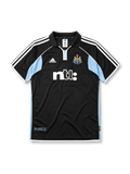 Newcastle United 2000-01 away jersey, front view, black body with sky blue side panels, black polo-style collar, white adidas logo and stripes, Newcastle United shield crest, white ntl sponsor logo, authentic product tag near hem