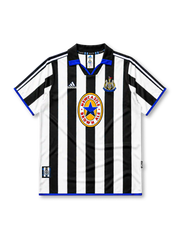 Newcastle United 1999-00 home jersey, front view, black and white vertical stripes, black polo-style collar with blue inset, white adidas logo, Newcastle United shield crest, circular Newcastle Brown Ale star sponsor badge