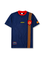 Spain 1996 away jersey, front view, navy body with tonal jacquard pattern, red button-placket collar, yellow adidas logo, bold red and yellow vertical stripe, Spanish royal crest, small Spain flag patch on sleeve