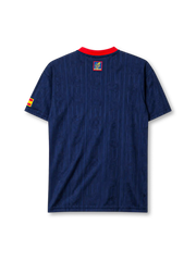 Spain 1996 away jersey, front view, navy body with tonal jacquard pattern, red button-placket collar, yellow adidas logo, bold red and yellow vertical stripe, Spanish royal crest, small Spain flag patch on sleeve