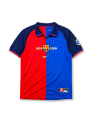 Barcelona 1999-2000 home jersey, front view, split red and blue design, navy raglan sleeves, navy polo-style collar, gold 1899 and 1999 centenary text, Barcelona crest, white Nike swoosh, circular centenary emblem on sleeve