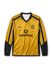 Manchester United 2001-02 away long-sleeve jersey, front view, gold body with black side panels and long sleeves, black V-neck collar with white piping, black Umbro logo, Manchester United shield crest, black Vodafone sponsor logo