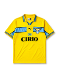 Lazio 1998-99 away jersey, front view, bright yellow body with sky blue chest band, yellow polo-style collar with black and blue trim, black Puma logo, S.S. Lazio eagle crest, Cirio sponsor logo and badge, sky blue cuffs