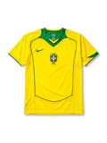 Brazil 2004 home jersey, front view, yellow body with green V-neck collar, curved seam piping, Nike swoosh logo, CBF crest with five stars, Brasil text