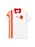 Spain 1994 away jersey, front view, white body with red and gold diamond pattern, red point collar with gold and navy stripes, adidas wordmark, Royal Spanish Football Federation crest