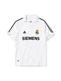 Real Madrid 2005-06 home jersey, front view, white body with black adidas three-stripe shoulder detailing, point collar, adidas logo, club crest, Siemens sponsor logo