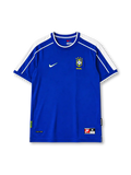 Brazil 1998 away jersey, front view, blue body with white raglan shoulder panels, white crew-neck collar with blue trim, red Nike swoosh, CBF crest with four stars, Brasil text beneath crest