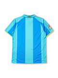Barcelona 2007-08 away jersey, front view, two-tone sky blue vertical stripes, polo-style collar with green trim, yellow Nike swoosh, Camp Nou 1957-2007 anniversary crest, yellow unicef sponsor logo, La Liga patch on sleeve