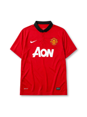 Manchester United 2013-14 home jersey, front view, red body, black polo-style collar with button placket, white Nike swoosh, Manchester United crest, white AON sponsor logo