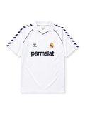 Real Madrid 1986-87 home jersey, front view, white body with navy Hummel chevron sleeve pattern, polo-style collar with navy piping, navy Hummel logo, Real Madrid crest with crown, navy Parmalat sponsor logo