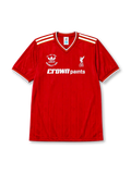 Liverpool 1986-87 home jersey, front view, red body, white V-neck collar with gold piping, white and gold adidas stripes, F.A. Cup Final Wembley 1986 commemorative text, white L.F.C. liver bird crest, white Crown Paints sponsor logo